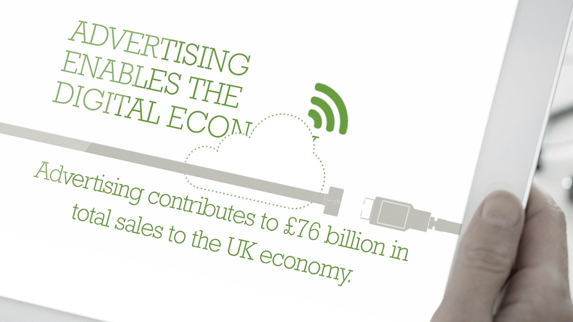 A person's hand holding an electronic tablet displaying the Advertising Association Ad Pays Report Advertising's Contribution to UK Economy Infographic