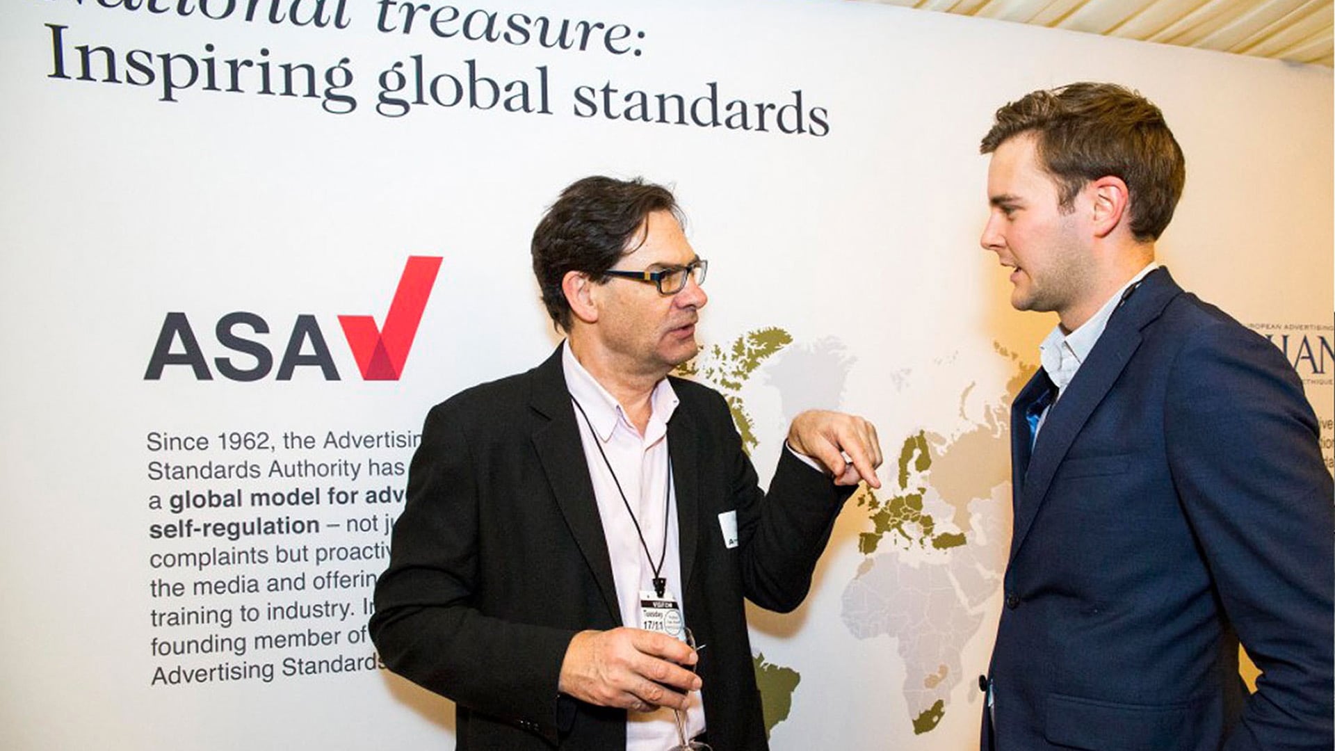 Two men in discussion at the Advertising Association Ad Pays Report Parliament Event stand