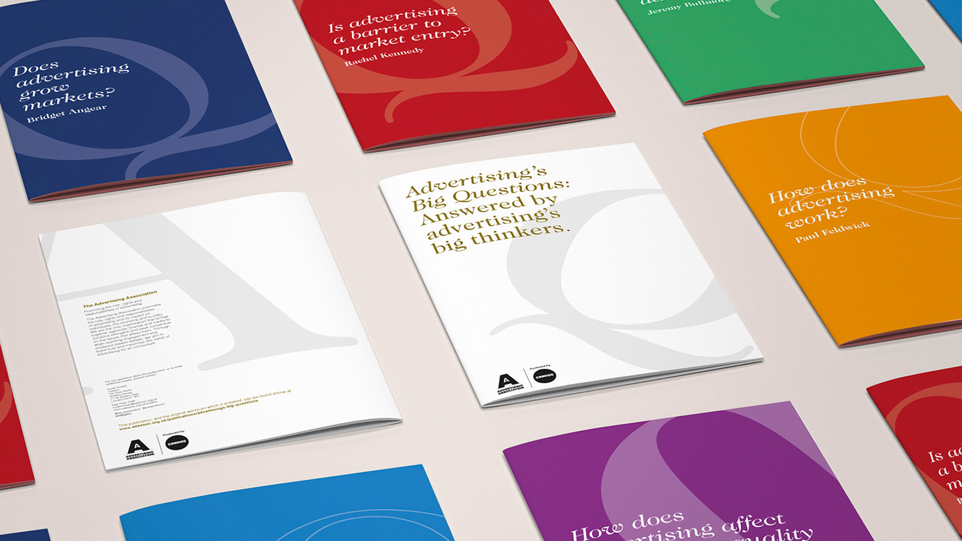A colourful selection of Advertising Association Credos Reports brochures displayed on a grey surface.