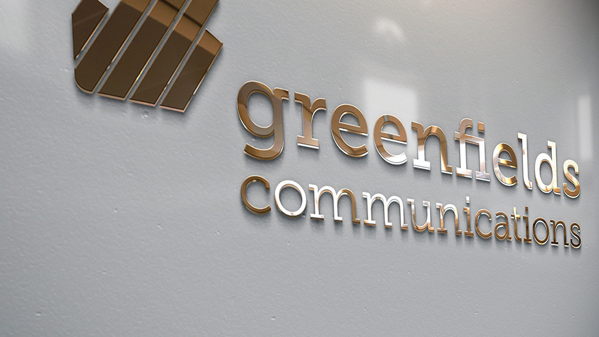 A close-up of the Greenfields Communications logo Metal Signage