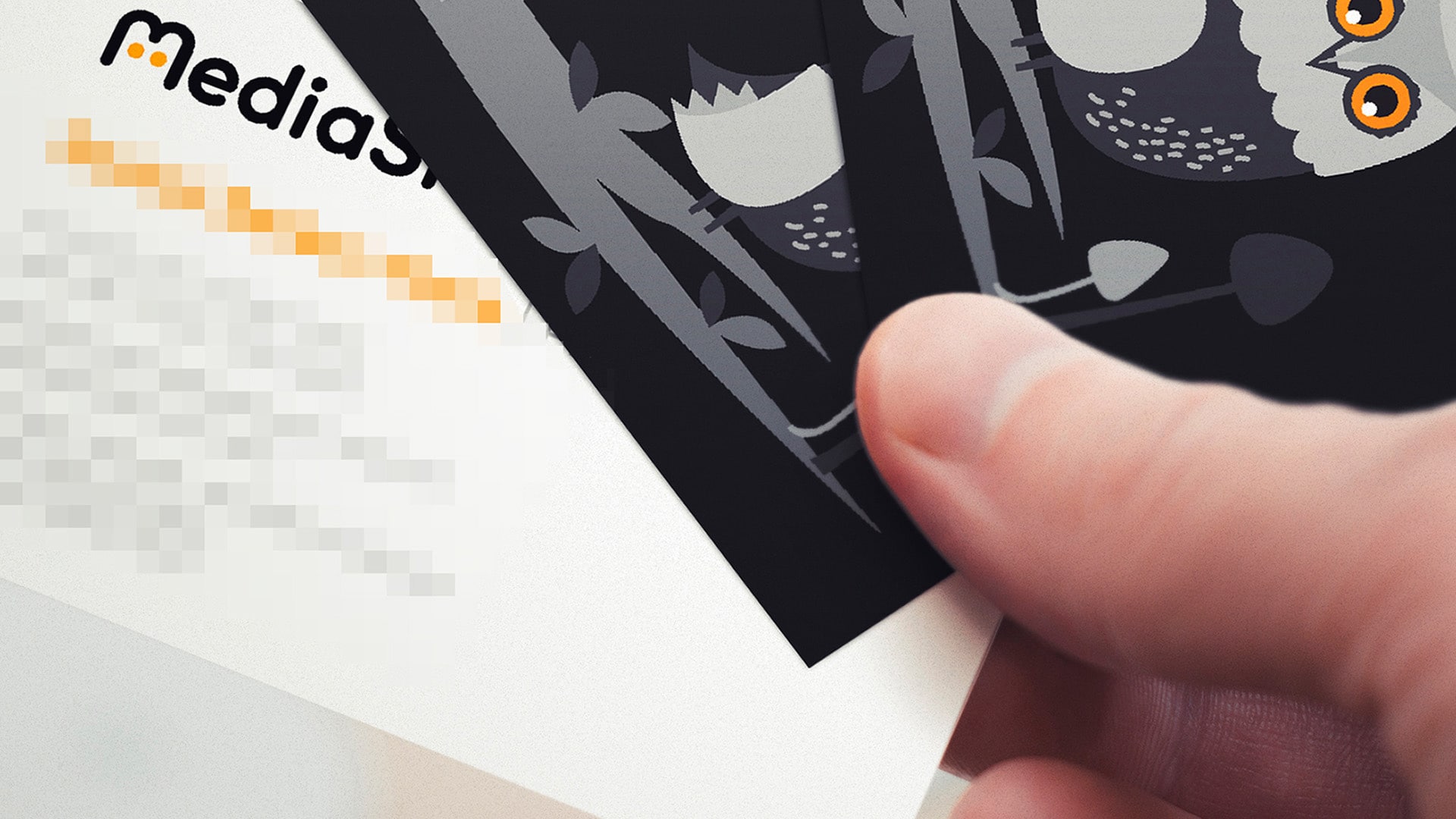 A close up image of two Media Smart business cards