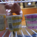 A photo of a hand grabbing an ice cream tub from the inside of a freezer, in a shot for the PR Academy video