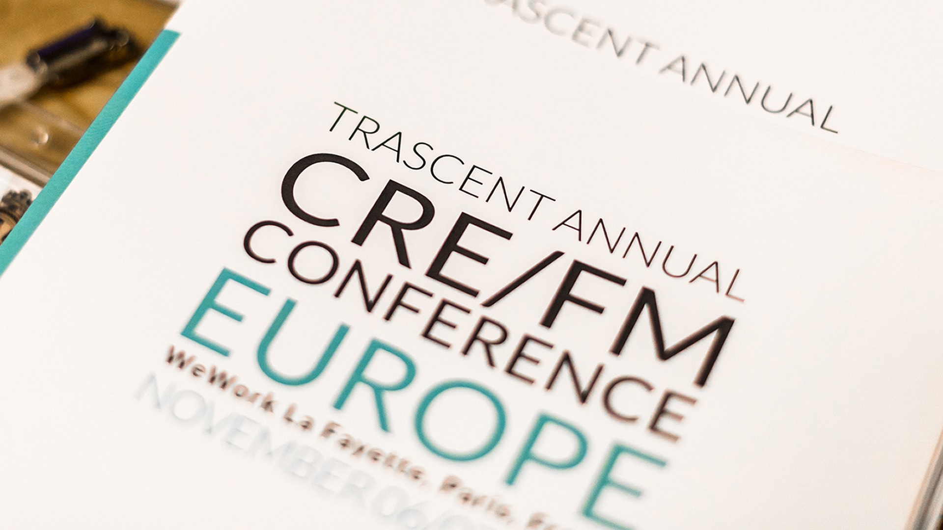A close-up photographic section of a printed Trascent Europe Conference Brochure